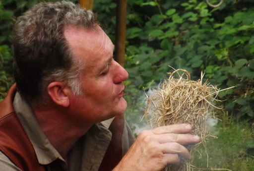 Dave Watson blowing on an ember