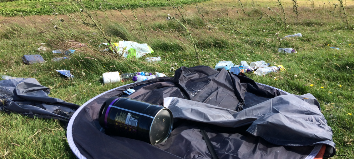 An abandoned tent and rubbish on Harbour Hill in the Pentlands.